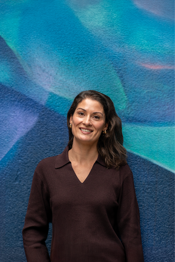 picture of Camila Rahde standing in front of a blue backdrop